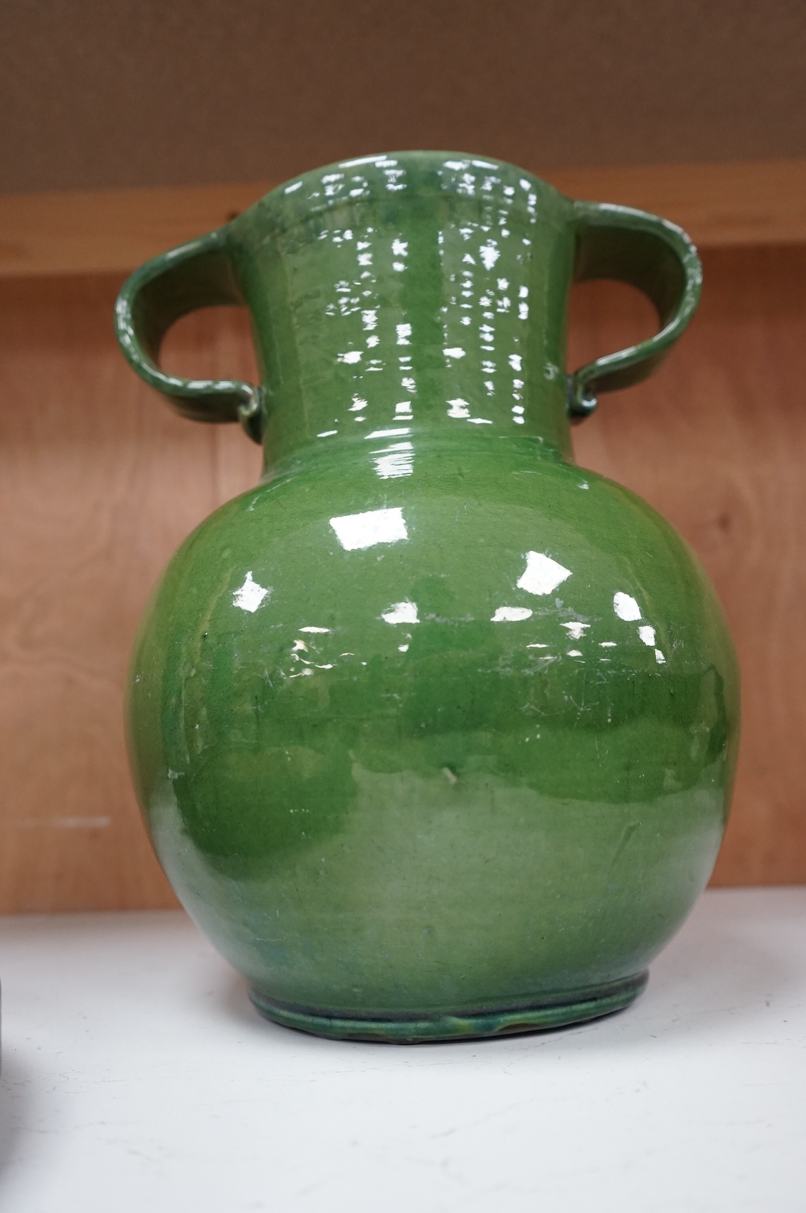 A Brannam green glazed twin handled vase, 29cm high